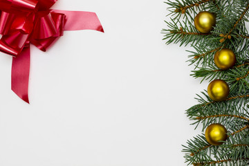 Creative Composition Useful for Christmas and New Year Greeting Card Created Using Decorative Balls, Green Pine Branches and Red Bow. Copy Space on The Left and Middle