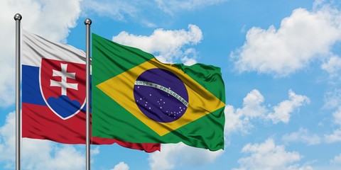 Slovakia and Brazil flag waving in the wind against white cloudy blue sky together. Diplomacy concept, international relations.