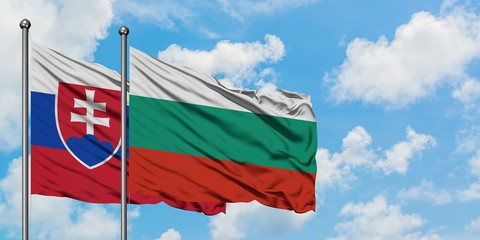 Slovakia and Bulgaria flag waving in the wind against white cloudy blue sky together. Diplomacy concept, international relations.