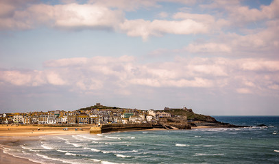 Harbour at St Ives with waves crashing against the harbour wall taken at sunset in St Ives, Cornwall,