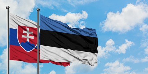 Slovakia and Estonia flag waving in the wind against white cloudy blue sky together. Diplomacy concept, international relations.