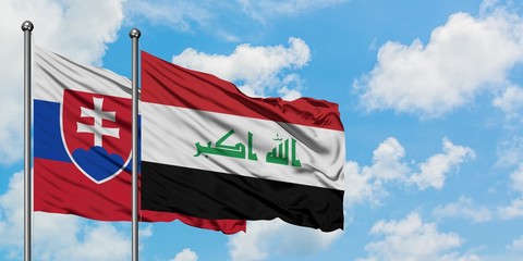 Slovakia and Iraq flag waving in the wind against white cloudy blue sky together. Diplomacy concept, international relations.