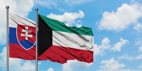 Slovakia and Kuwait flag waving in the wind against white cloudy blue sky together. Diplomacy concept, international relations.