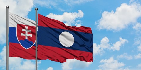 Slovakia and Laos flag waving in the wind against white cloudy blue sky together. Diplomacy concept, international relations.
