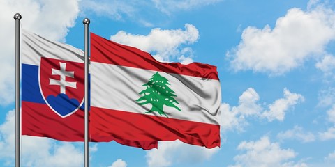 Slovakia and Lebanon flag waving in the wind against white cloudy blue sky together. Diplomacy concept, international relations.