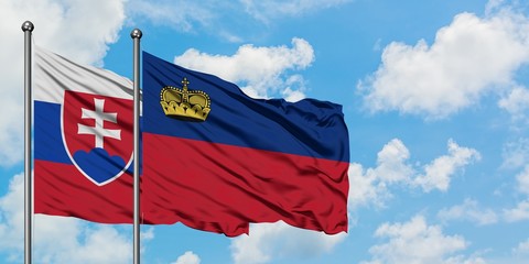 Slovakia and Liechtenstein flag waving in the wind against white cloudy blue sky together. Diplomacy concept, international relations.