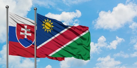 Slovakia and Namibia flag waving in the wind against white cloudy blue sky together. Diplomacy...