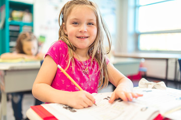 education and school concept little student girl studying at school