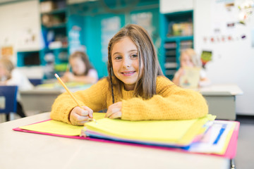 education and school concept little student girl studying at school
