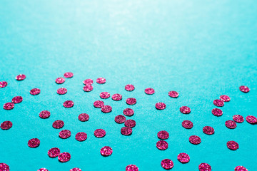Bright pink round confetti on a blue background, holiday background