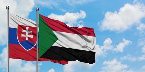Naklejka na ściany i meble Slovakia and Sudan flag waving in the wind against white cloudy blue sky together. Diplomacy concept, international relations.