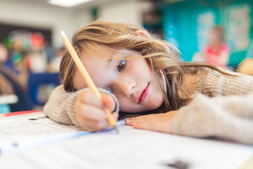 education and school concept little student girl studying at school