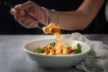 Woman Enjoying her pasta dinner