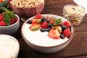 Tasty homemade granola served on table. Healthy breakfast with a bowl of oatmeal with banana, blueberries, strawberries and healthy food for Breakfast