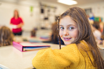 education and school concept little student girl studying at school
