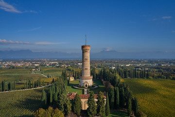 Aerial view. Tower of San Martino della Battaglia, Italy. Autumn season, tower surrounded by vineyards, blue sky