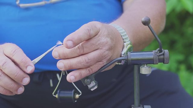 Man tying fly for fly fishing. do it yourself