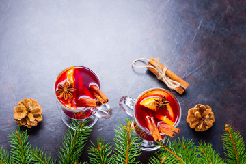 Mulled wine in glass mug with spices. Glasses of mulled wine with cinnamon, anise and fir tree...