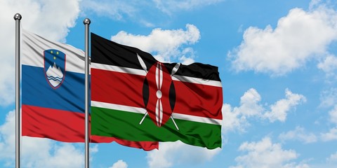 Slovenia and Kenya flag waving in the wind against white cloudy blue sky together. Diplomacy...