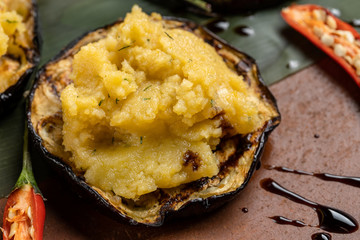 Pumpkin puree is laid out on grilled eggplant.
