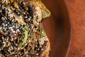 Pasta with mushrooms, zucchini zucchini. On a beautiful clay plate.