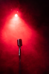 vintage microphone in smoke on red stage