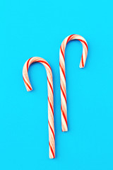 Christmas composition. Candy cane decorations on blue background. Christmas, winter, new year and holiday card.