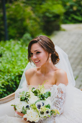 Close-up portrait of attractive bride in white dress with naked shoulders