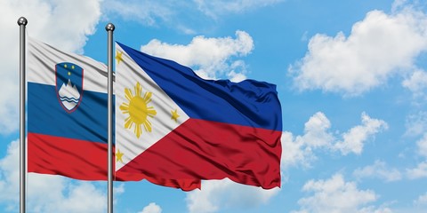 Slovenia and Philippines flag waving in the wind against white cloudy blue sky together. Diplomacy concept, international relations.