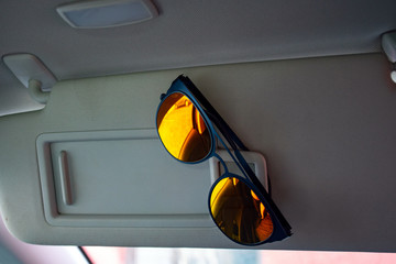 sunglasses in a car´s sun visor 