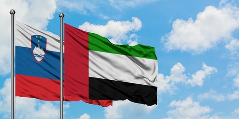Slovenia and United Arab Emirates flag waving in the wind against white cloudy blue sky together. Diplomacy concept, international relations.