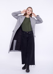 Fototapeta premium Beautiful fashion model in gray coat isolated on white background