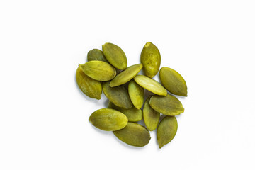 Seeds of gymnospermous pumpkin lie in the center on a white background