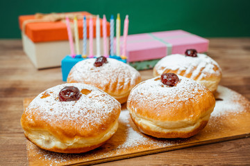 nine candles and doughnuts with sugar powder (jewish holiday Hanukkah)