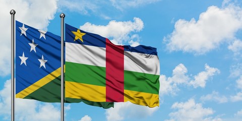 Solomon Islands and Central African Republic flag waving in the wind against white cloudy blue sky together. Diplomacy concept, international relations.