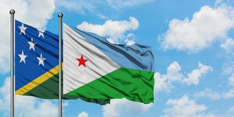 Solomon Islands and Djibouti flag waving in the wind against white cloudy blue sky together....