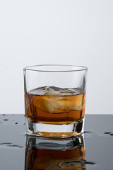 a glass of whiskey, drops, spray, splash of fluid, a stop time, after a hard working day, rest time, Scottish traditions, Irish drink, Bourbon or Scotch,