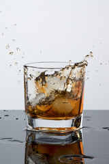 a glass of whiskey, drops, spray, splash of fluid, a stop time, after a hard working day, rest time, Scottish traditions, Irish drink, Bourbon or Scotch,