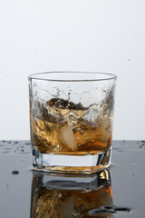 a glass of whiskey, drops, spray, splash of fluid, a stop time, after a hard working day, rest time, Scottish traditions, Irish drink, Bourbon or Scotch,