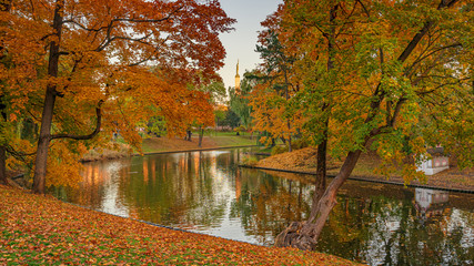 Beautiful autumn colors in the park with river. Riga, Latvia