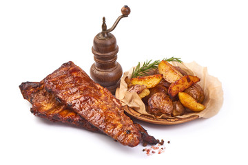 Grilled pork ribs with baked crispy potatoes, Delicious roasted hot ribs, isolated on white background