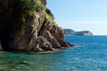 Naklejka premium Sea, rocks and Sveti Stefan island from Rafailovici beach