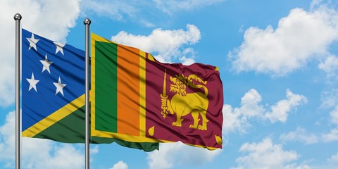 Solomon Islands and Sri Lanka flag waving in the wind against white cloudy blue sky together. Diplomacy concept, international relations.