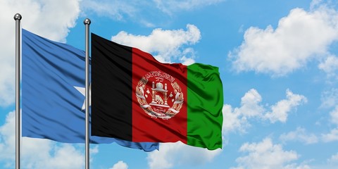 Somalia and Afghanistan flag waving in the wind against white cloudy blue sky together. Diplomacy...