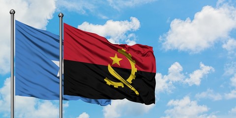 Somalia and Angola flag waving in the wind against white cloudy blue sky together. Diplomacy...