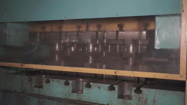 The process of processing metal billets in old machine tools of heavy engineering plants. Moving parts of processing machines