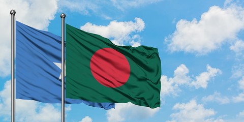 Somalia and Bangladesh flag waving in the wind against white cloudy blue sky together. Diplomacy...