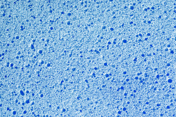 Blue porous sponge texture. Closeup macro foam background.