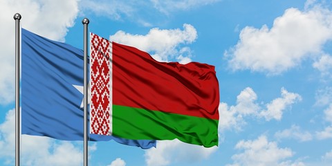Somalia and Belarus flag waving in the wind against white cloudy blue sky together. Diplomacy...