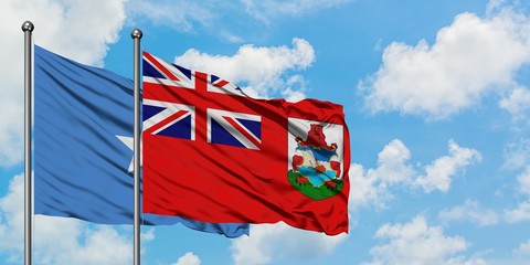 Somalia and Bermuda flag waving in the wind against white cloudy blue sky together. Diplomacy concept, international relations.